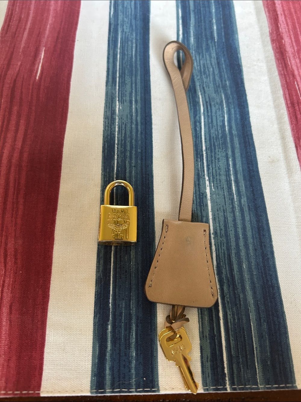 MCM jet and lock gold color with cream lanyard amazing condition